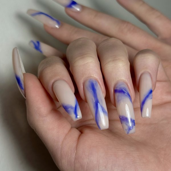Nude almond nails with blue marble line art
