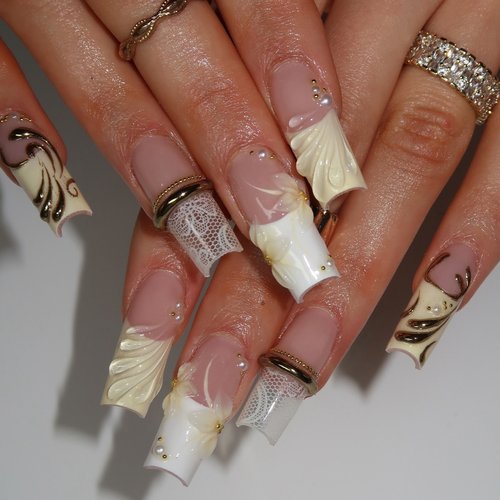 Long nude nails with white 3D gel art and gold accents